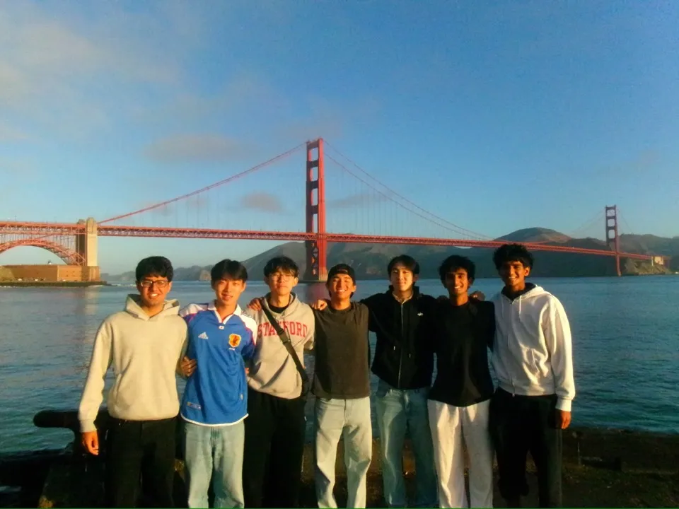 Seven friends in front of the Golden Gate Bridge at sunset