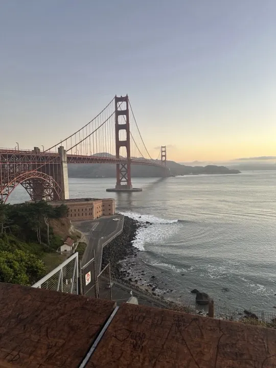 The Golden Gate Bridge from a cliffside overlook at dusk